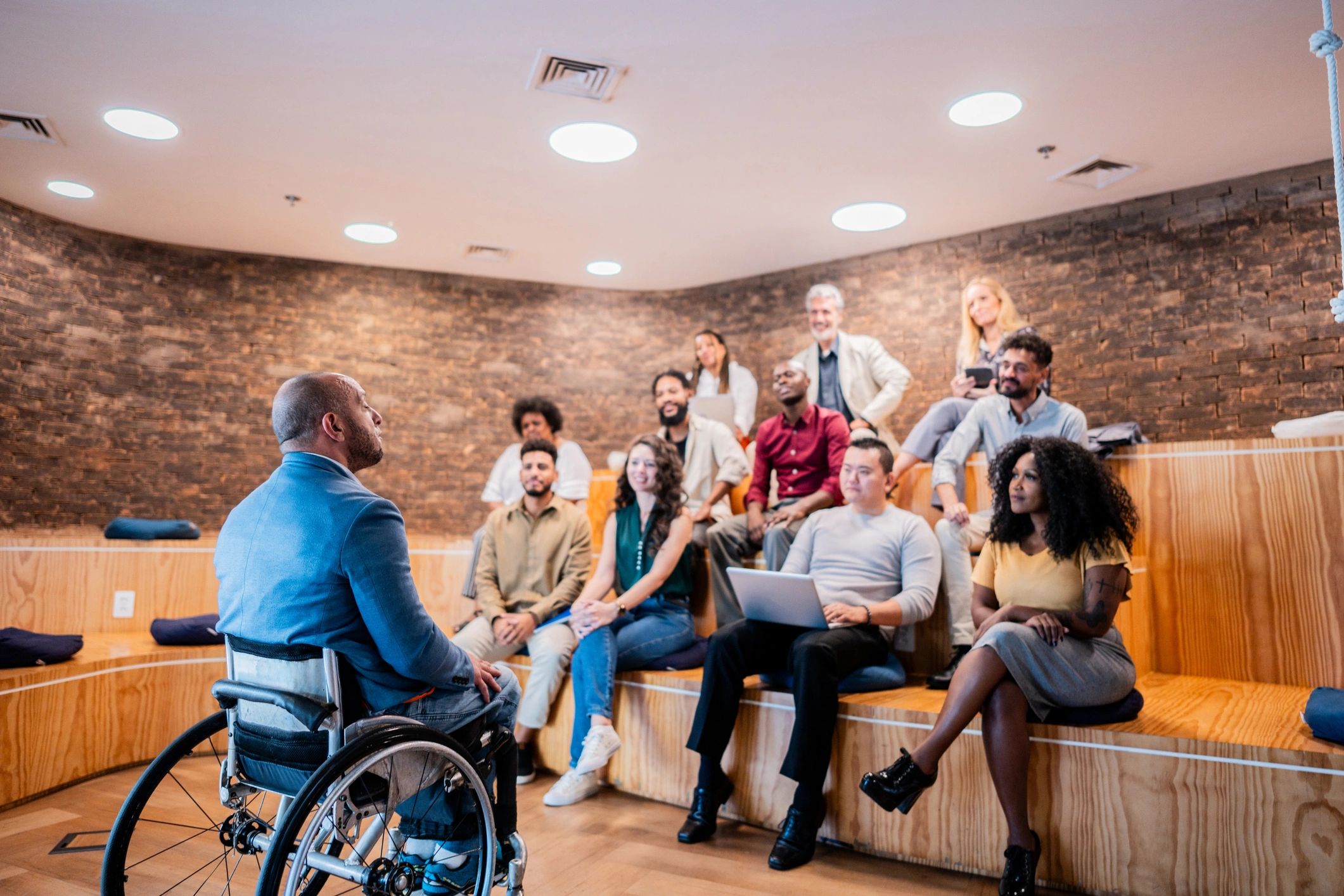 Wheelchair user leading a community presentation